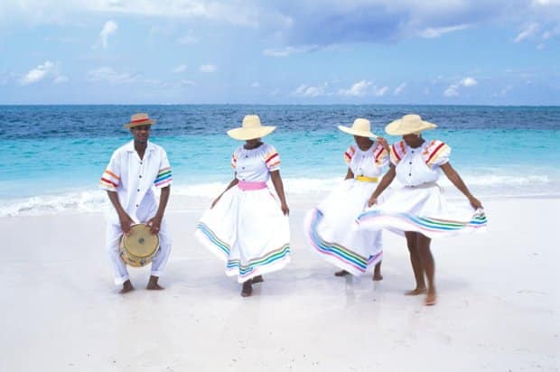 People dancing on a beach in Turks and Caicos where RE/MAX Real Estate group sells Turks and Caicos real estate